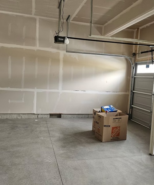 Garage walls with new drywall, taped and mudded