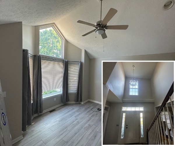 Freshly painted room with tall windows, and a two-story entry with a staircase