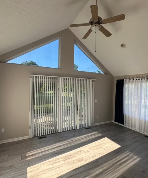 Sunlit room with a vaulted ceiling, triangle windows and freshly painted walls