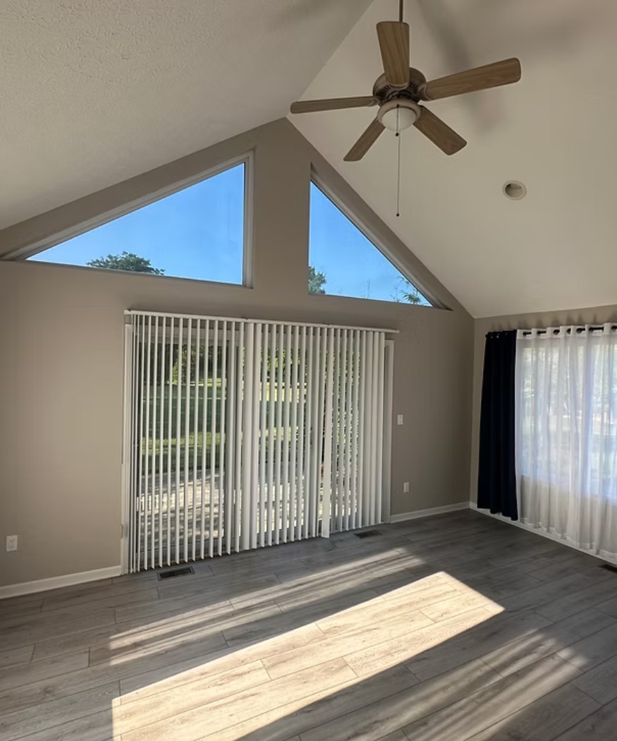 Sunlit room with a vaulted ceiling, triangle windows and freshly painted walls